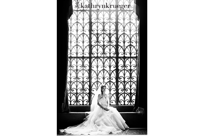 Bridal portrait sitting in front of intricate window.