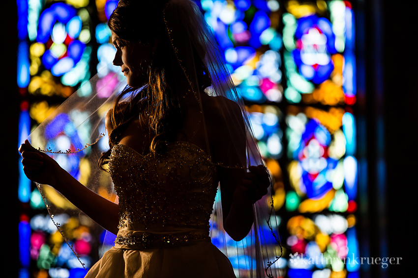 Bridal portrait in front of stained glass window. 