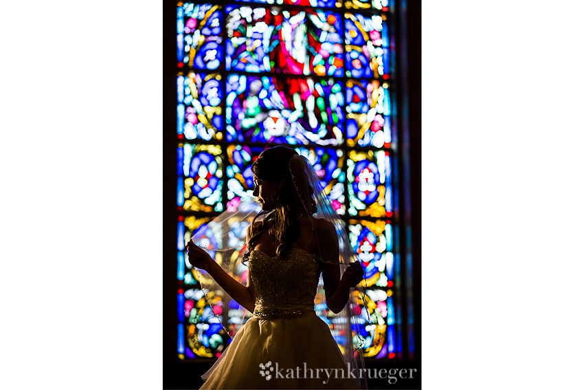 Bridal portrait in front of stained glass window. 