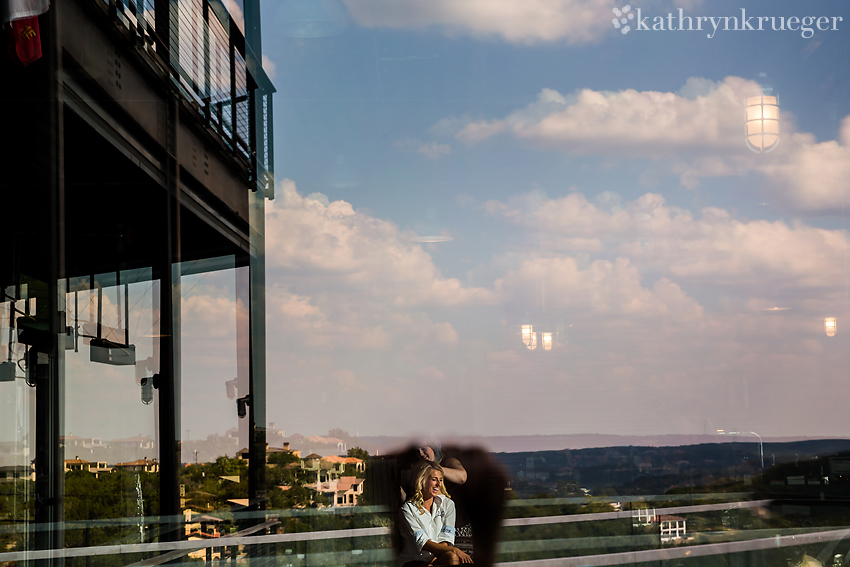 Bride getting ready in reflection with landscape behind.