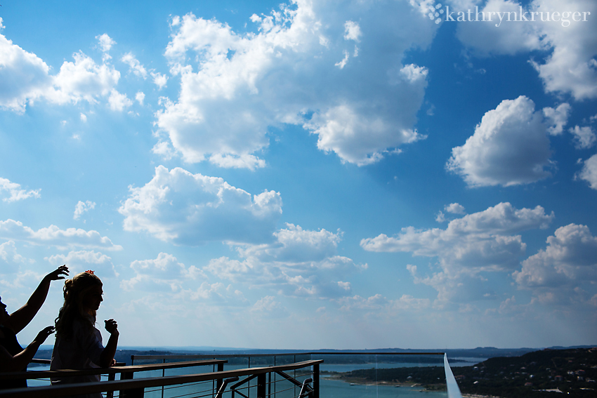 Bride getting flower in hair with sky in the back.