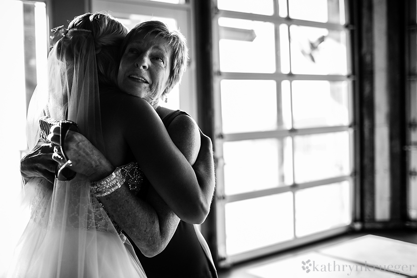 Black and white of bride and mother hugging.