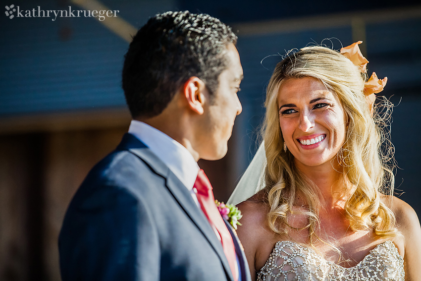 Bride smiling at groom during ceremony.