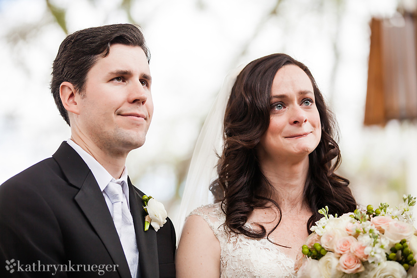 Bride and groom at altar showing emotion.