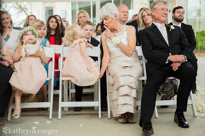 Mother of the groom shushing the flower girls.