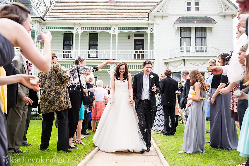 Bride and groom being showered with sprinkles as they leave.