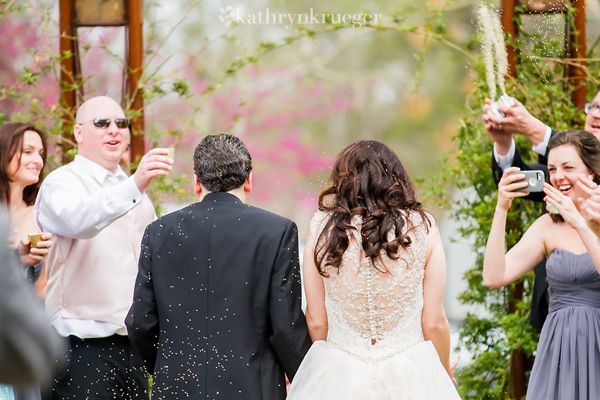 Shot from behind the bride and groom as they leave.