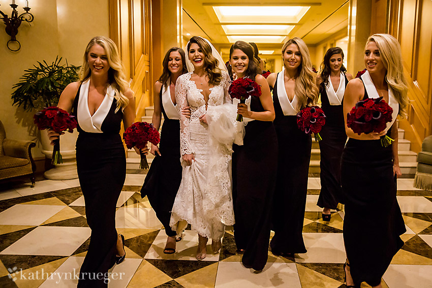 Bride and bridesmaids walking happily to ceremony.