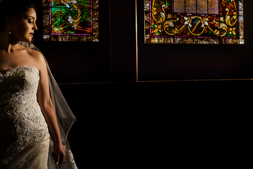 Bride in front of stained glass window