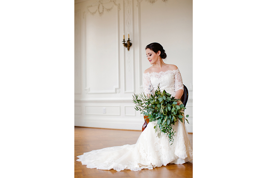 Bride sitting on a chair holding a bouquet