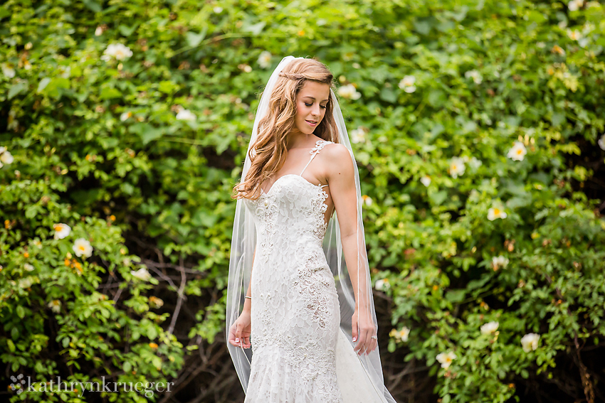 Bridal portrait in front of spring foliage. 