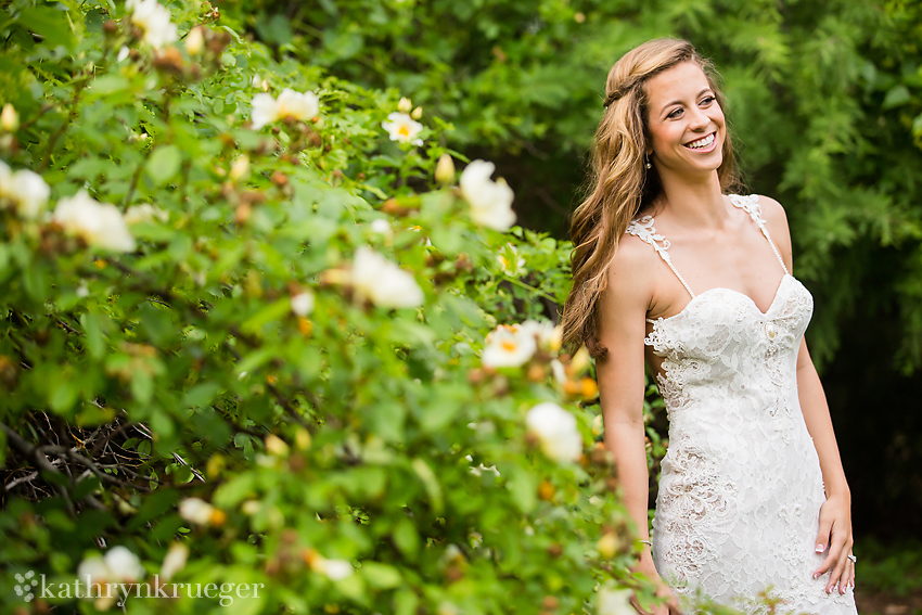 Bridal portrait standing next to spring foliage.