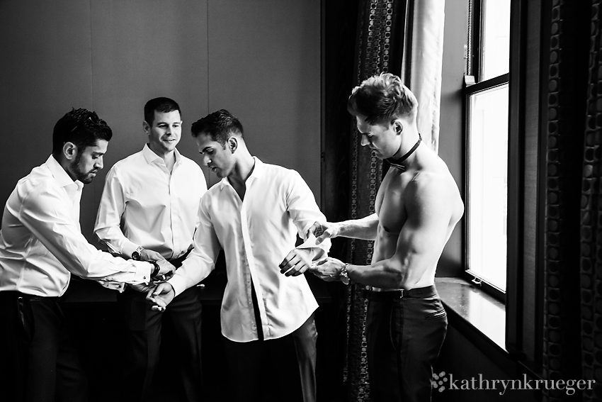 Groomsmen dressing a groom