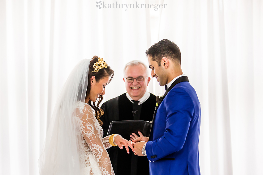 Groom puts ring on bride