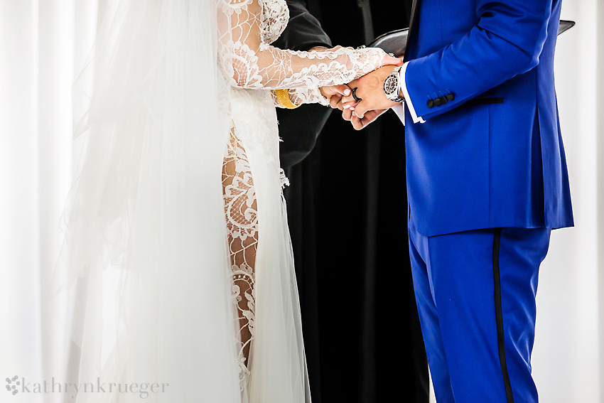 Bride and groom hold hands