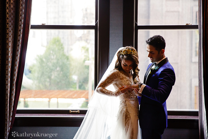 Bride and Groom look at new rings