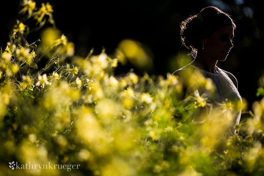 Bridal portrait surrounded by foliage bride has a halo of light.