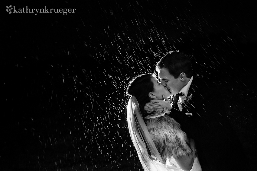 Kissing bride and groom in the snow