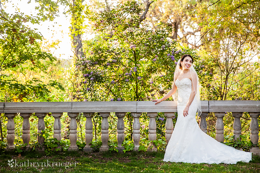 Bridal portrait standing with stone railing.