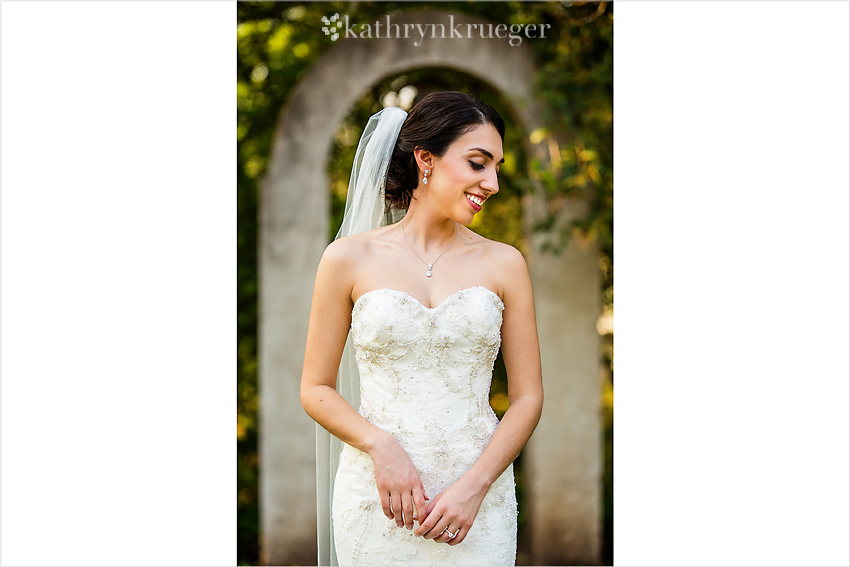 Bridal portrait standing in front of archway.