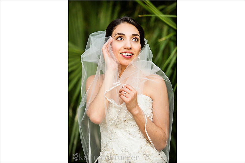 Bridal portrait in front of green foliage. 